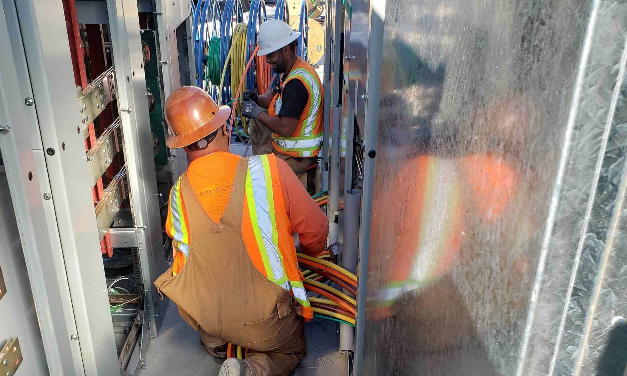 two men working on a fuel cell