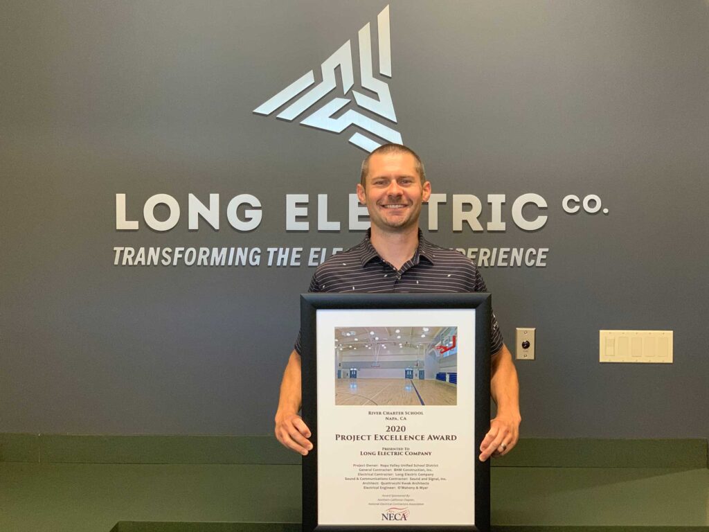 Tom Long holds the award for the 2020 NorCal NECA Project Excellence for work on the River Charter School project